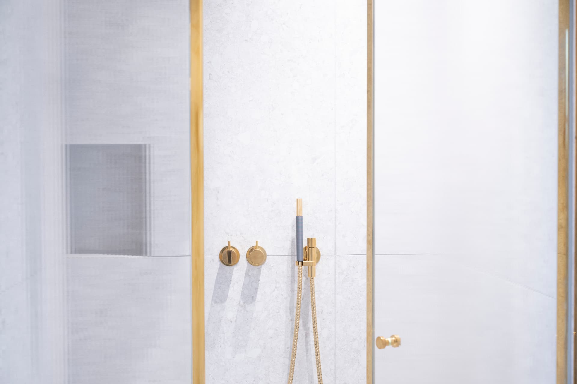Detail der Dusche im Hauptbad mit goldfarbenen Armaturen und Glasabtrennung – Villa Konitzer Straße, München · Bogenhausen