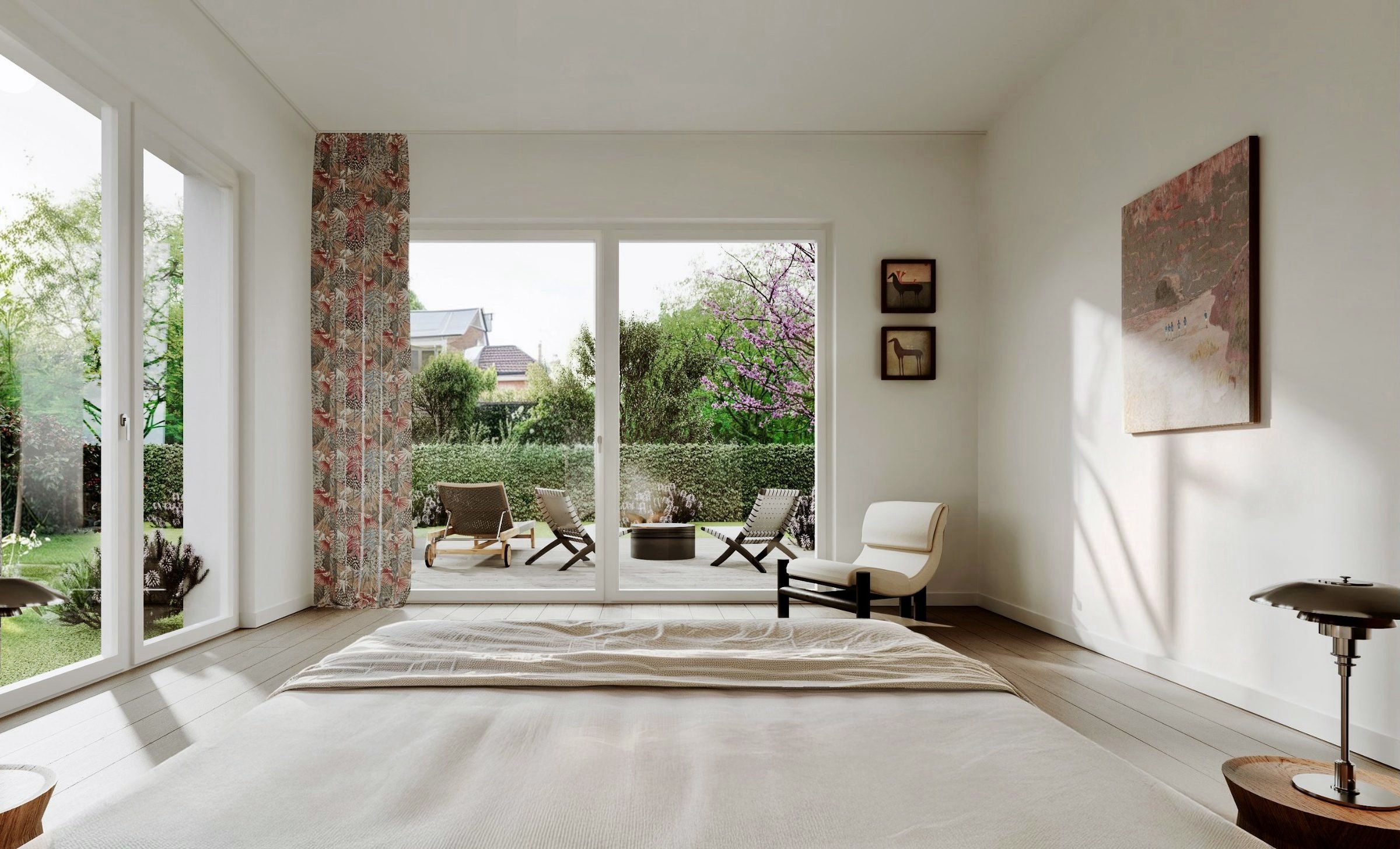 Schlafzimmer der Gartenwohnung mit bodentiefen Fenstern und Blick auf Terrasse und Garten