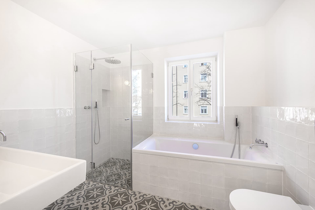 Bad im Obergeschoss mit Badewanne, Glasdusche und gemusterten Bodenfliesen – Stadthaus Virchowstraße, München · Schwabing